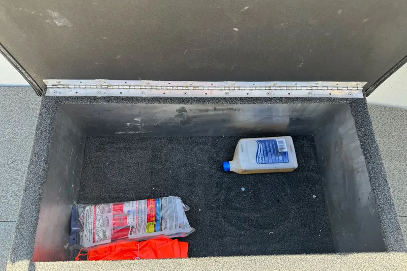 Slide: The Image of Storage compartment in a 2006 North River 21 Seahawk boat with supplies. - 17