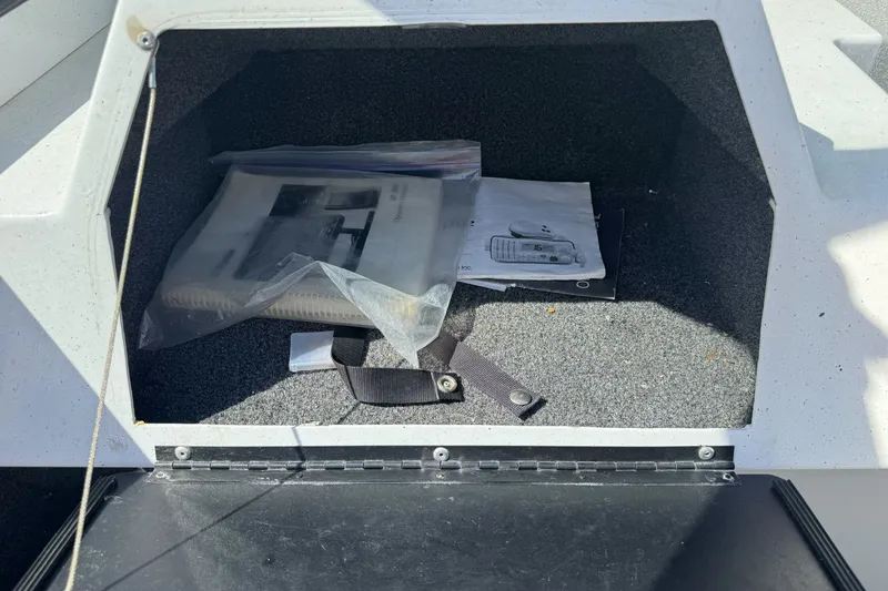 Slide: The Image of Storage compartment of a 2006 North River 21 Seahawk boat with manuals and accessories. - 21