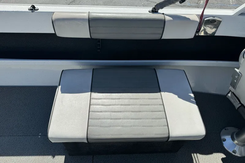 Slide: The Image of Interior seating of a 2006 North River 21 Seahawk boat, featuring gray upholstery. - 16