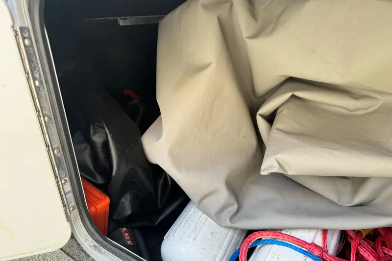 Slide: The Image of Storage compartment of a 2006 North River 21 Seahawk boat with ropes and covers. - 14