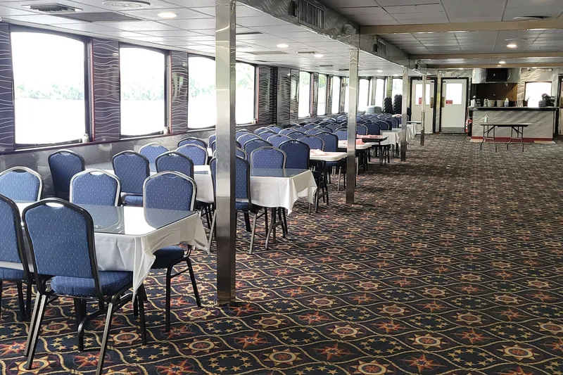 Slide: The Image of Interior of a 1985 custom dinner excursion passenger boat with blue chairs and patterned carpet. - 3