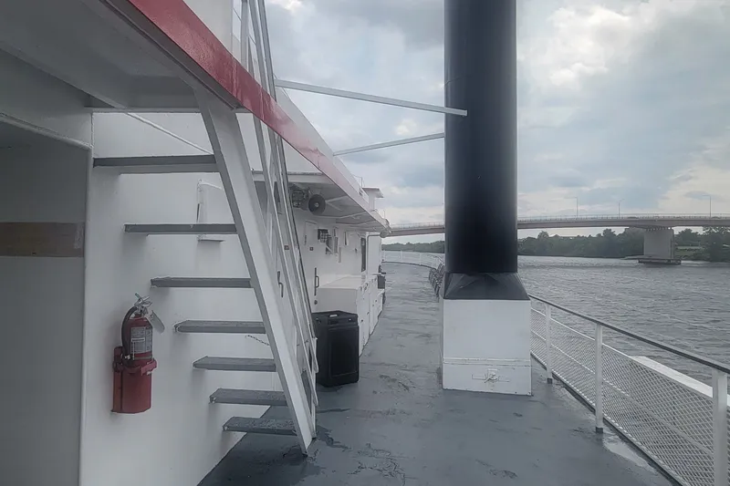 Slide: The Image of 1985 custom dinner excursion passenger boat deck with stairs and river view. - 12