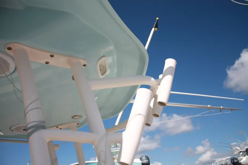 Slide: The Image of Close-up of a boat's T-top with fishing rod holders against a blue sky. - 38