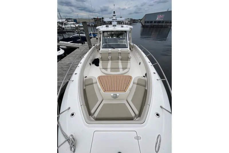 Slide: The Image of 2023 Boston Whaler 420 Outrage boat docked, showcasing spacious seating and sleek design. - 16
