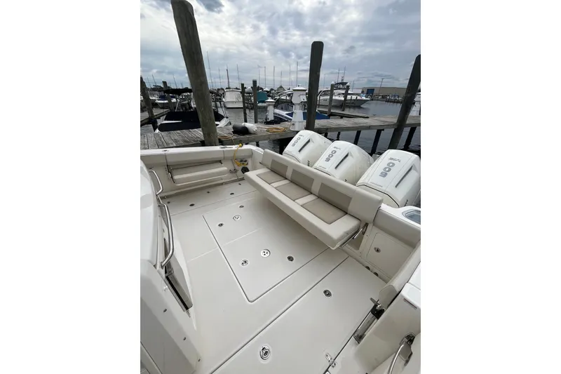 Slide: The Image of 2023 Boston Whaler 420 Outrage boat with spacious deck and powerful engines at marina. - 30