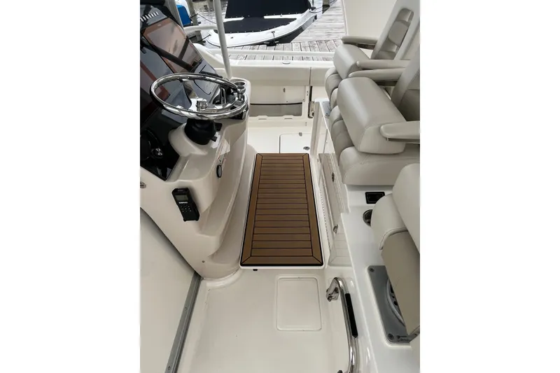 Slide: The Image of 2023 Boston Whaler 420 Outrage helm with steering wheel and seating area. - 18