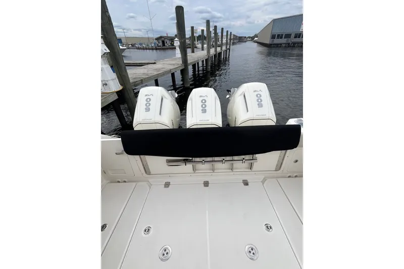 Slide: The Image of 2023 Boston Whaler 420 Outrage with triple 600hp engines docked at marina. - 22