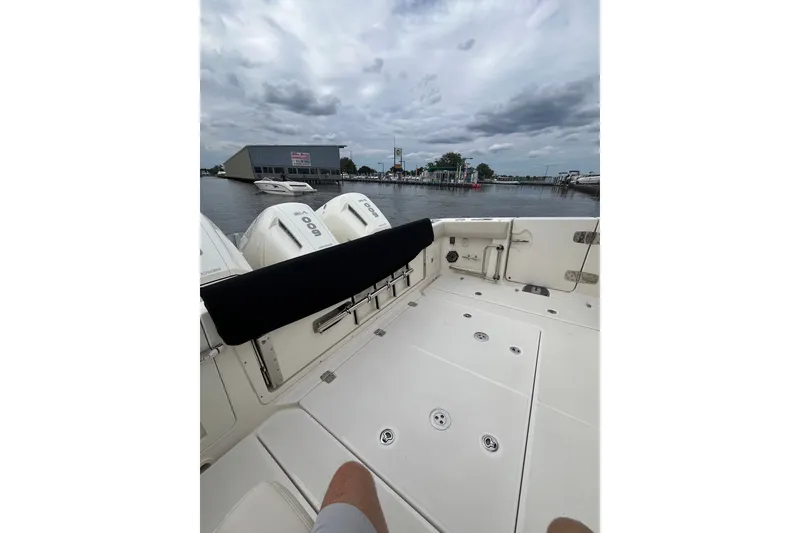 Slide: The Image of 2023 Boston Whaler 420 Outrage boat deck with engines, docked at marina. - 23