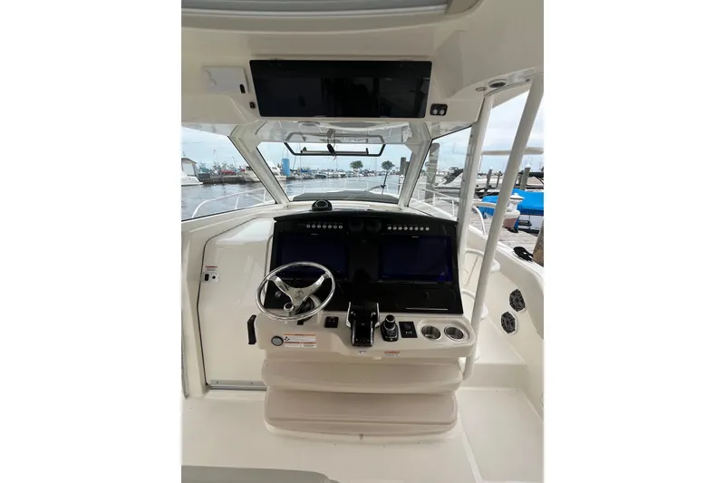 Slide: The Image of 2023 Boston Whaler 420 Outrage helm with modern controls and navigation displays. - 19