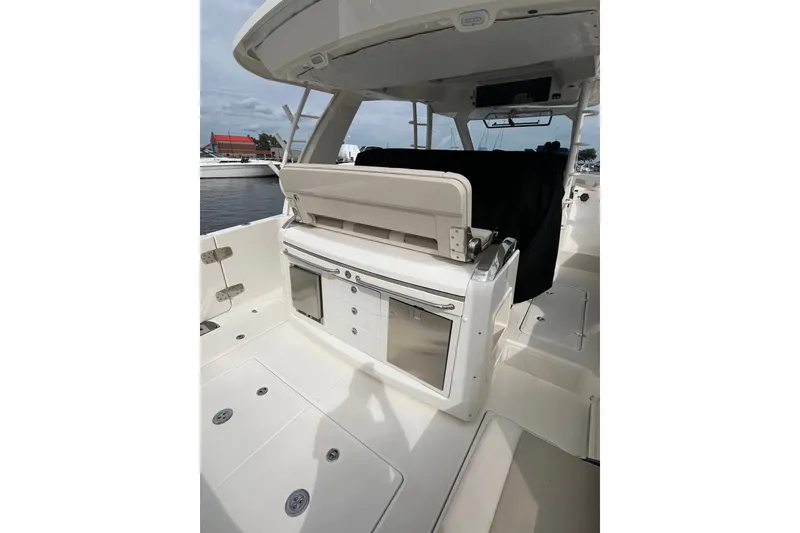 Slide: The Image of 2023 Boston Whaler 420 Outrage boat interior with seating and storage compartments. - 27
