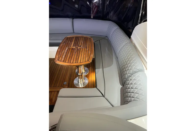 Slide: The Image of Luxurious seating area on 2016 Princess V39 yacht with elegant wooden table. - 34