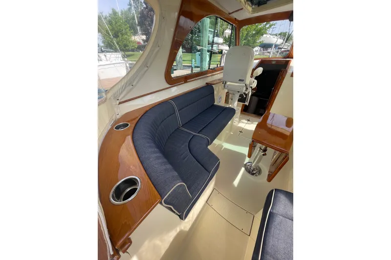 Slide: The Image of Interior of 2014 Hinckley Talaria 34 yacht with blue seating and wooden accents. - 7