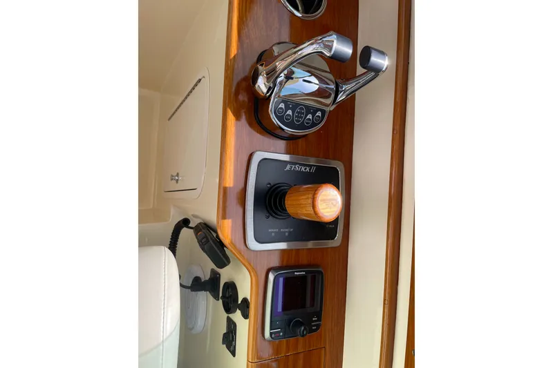 Slide: The Image of Control panel of a 2014 Hinckley Talaria 34 boat with joystick and throttle. - 12