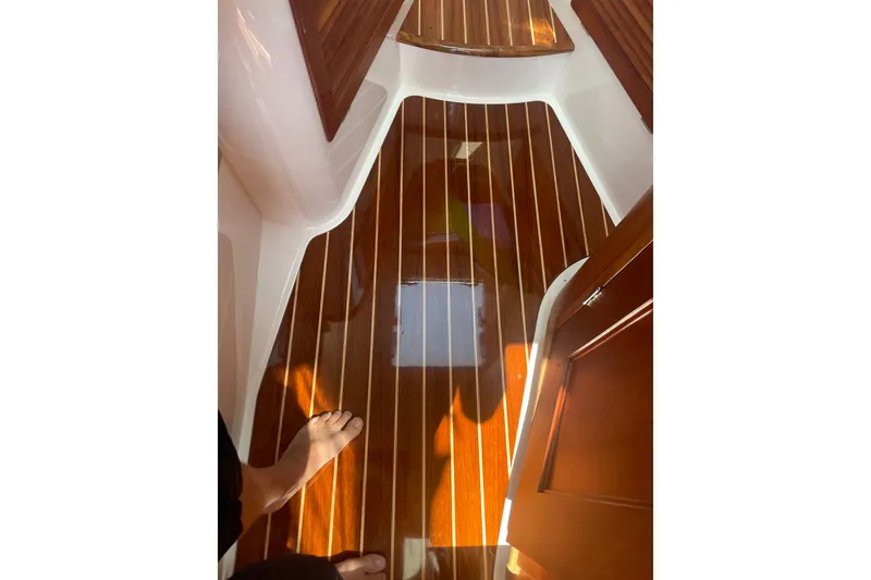 Slide: The Image of Interior view of 2014 Hinckley Talaria 34 boat with polished wooden flooring. - 8