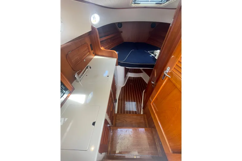 Slide: The Image of Interior of 2014 Hinckley Talaria 34 yacht with wooden finishes and compact cabin space. - 13