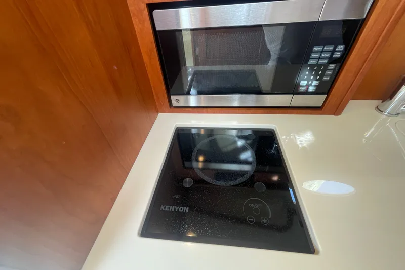Slide: The Image of 2014 Hinckley Talaria 34 kitchen with Kenyon cooktop and microwave. - 15