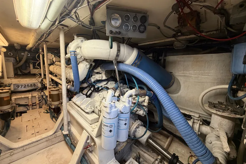 Slide: The Image of Engine room of a 1991 Bertram 60 Convertible yacht, showcasing machinery and components. - 23