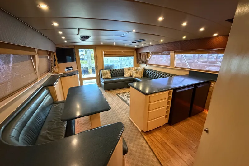 Slide: The Image of Luxurious interior of a 1991 Bertram 60 Convertible yacht with elegant seating and modern amenities. - 24