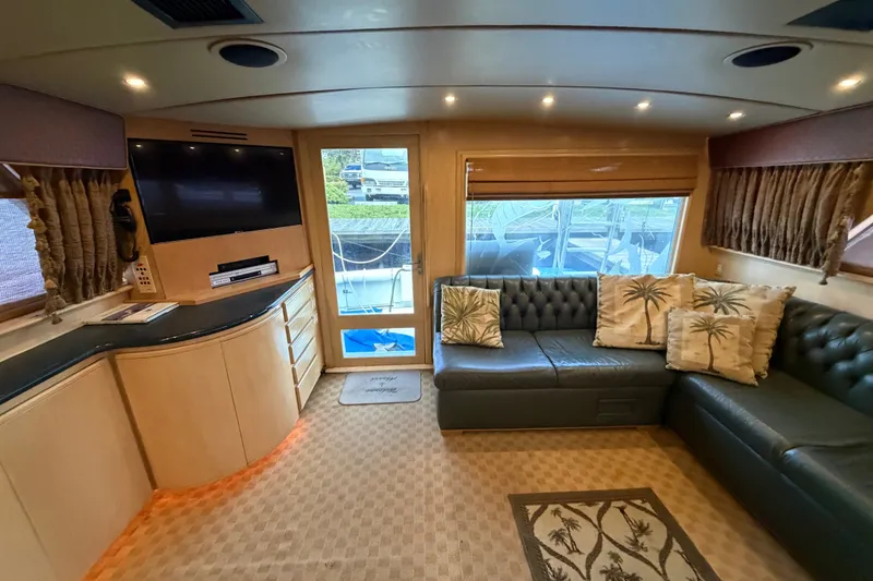 Slide: The Image of Luxurious interior of a 1991 Bertram 60 Convertible yacht with plush seating and modern amenities. - 27