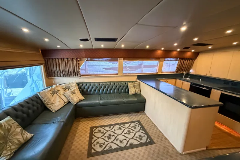 Slide: The Image of Luxurious interior of a 1991 Bertram 60 Convertible yacht with plush seating and modern kitchen. - 26