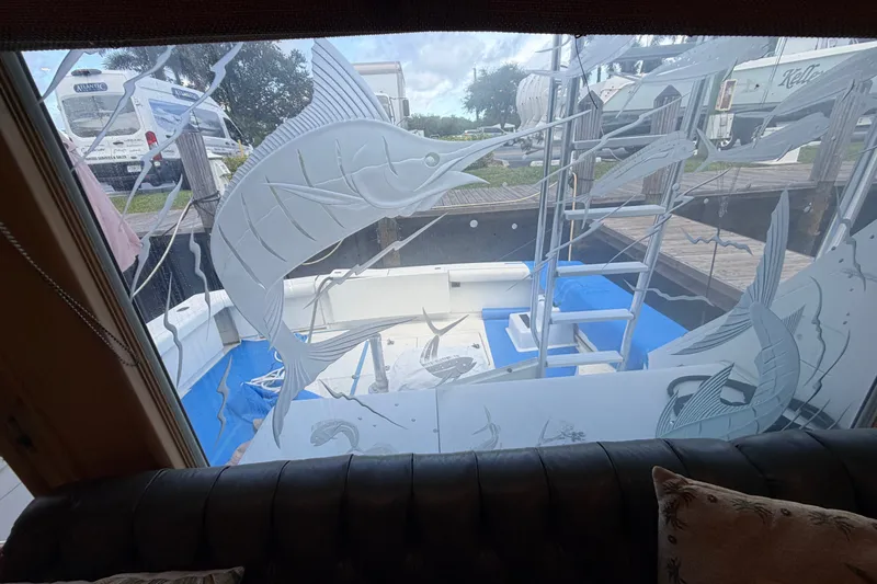 Slide: The Image of Interior view of a 1991 Bertram 60 Convertible yacht with etched glass fish design. - 29