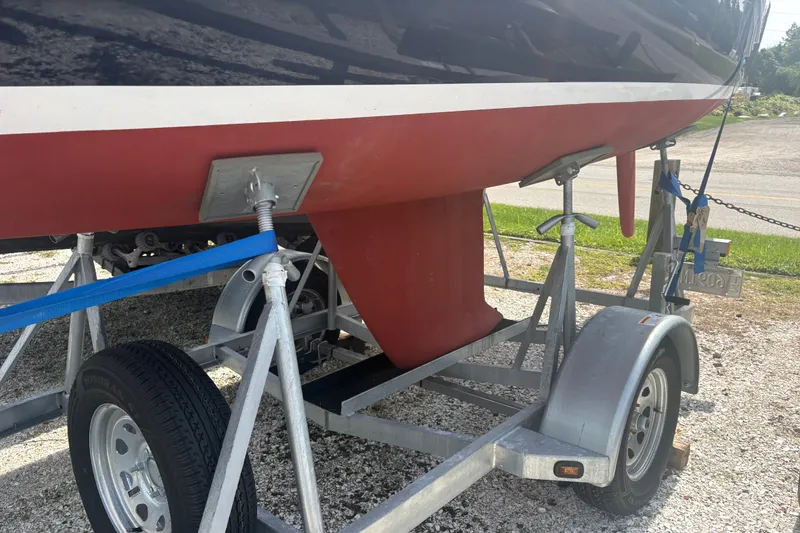 Slide: The Image of 2019 Alerion Express 20 sailboat on trailer, showing keel and hull details. - 17