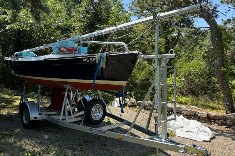 Slide: The Image of 2019 Alerion Express 20 sailboat on trailer, surrounded by trees and greenery. - 3