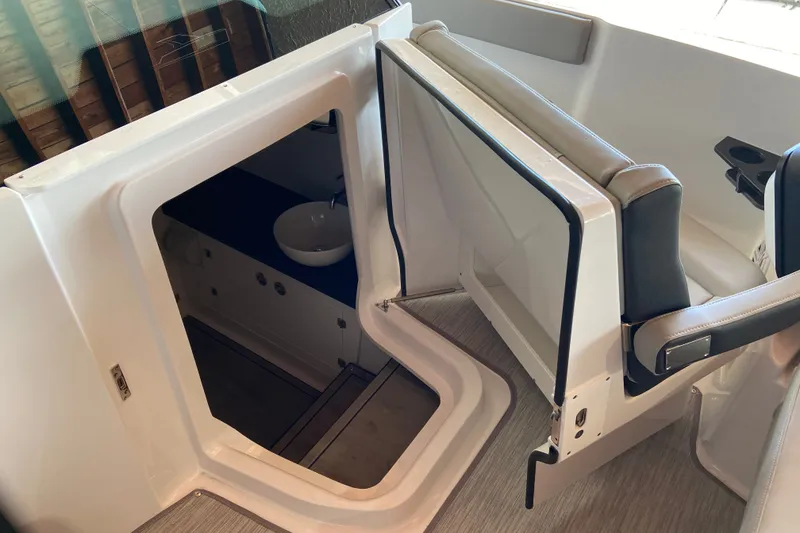 Slide: The Image of Interior view of 2027 Monterey Elite 27 OB boat, featuring cabin entrance and seating. - 21