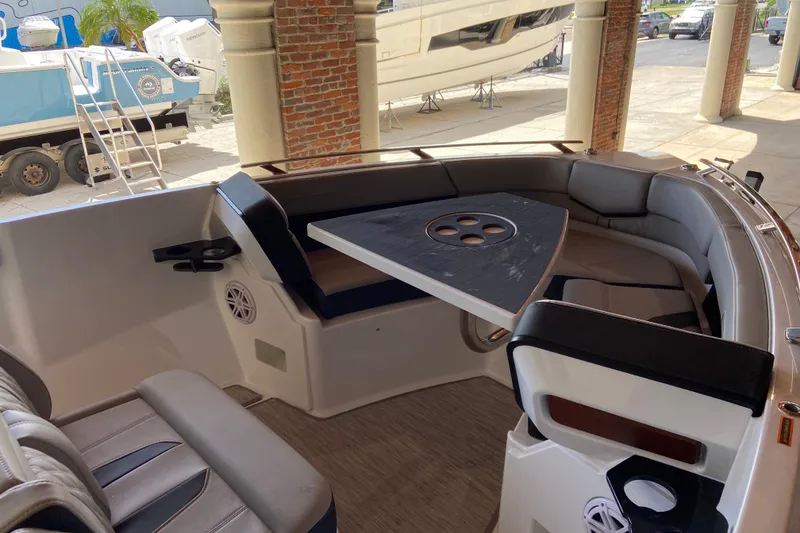 Slide: The Image of Luxurious seating area on 2027 Monterey Elite 27 OB boat, featuring a stylish table. - 18