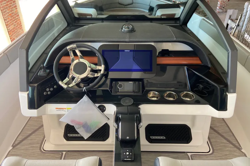 Slide: The Image of 2027 Monterey Elite 27 OB boat dashboard with modern steering and touchscreen display. - 14