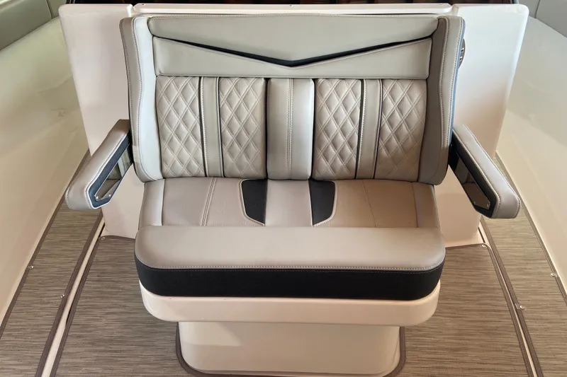 Slide: The Image of Luxurious seating on 2027 Monterey Elite 27 OB boat, featuring elegant diamond-pattern upholstery. - 20