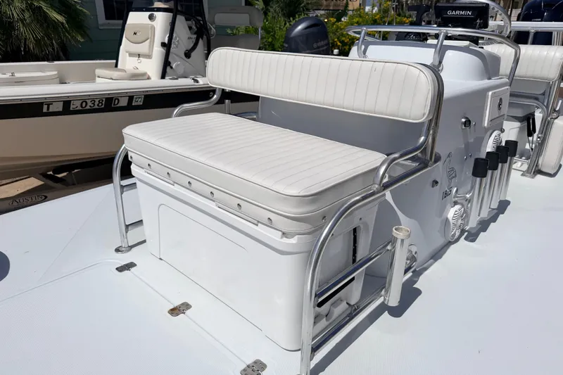 Slide: The Image of White seating area on a 2011 NewWater Ibis boat, featuring stainless steel railings. - 18