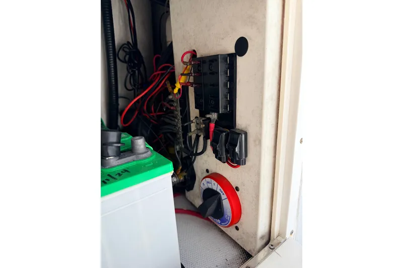 Slide: The Image of Electrical panel with wiring and battery in a 2011 NewWater Ibis boat. - 16