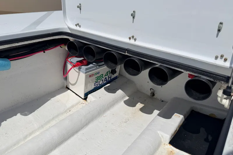 Slide: The Image of Battery compartment of a 2011 NewWater Ibis boat with wiring and storage tubes. - 32