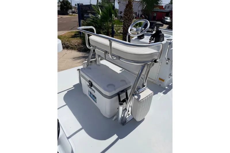 Slide: The Image of 2011 NewWater Ibis boat with white seating and Igloo cooler on deck. - 23
