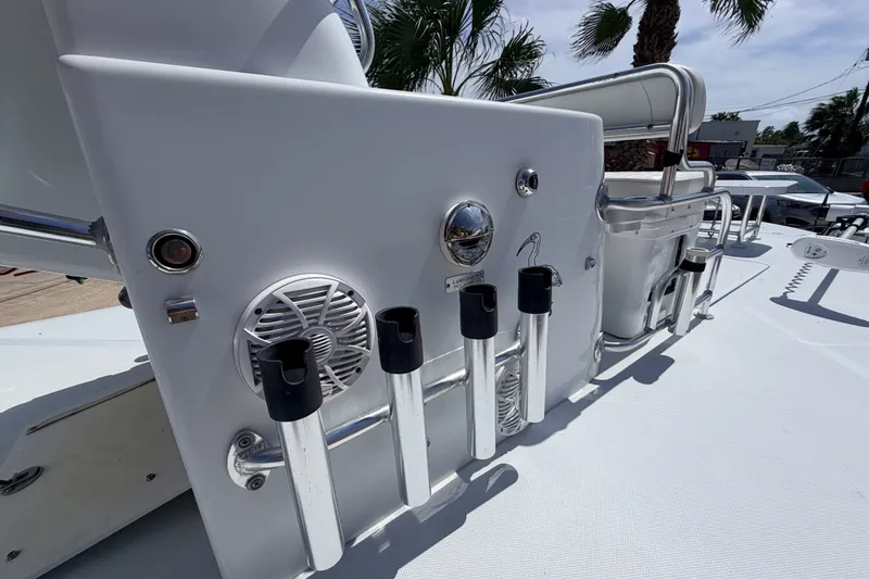 Slide: The Image of 2011 NewWater Ibis boat deck with rod holders and speaker, under sunny skies. - 19