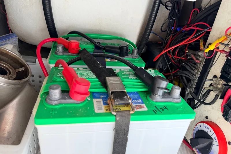 Slide: The Image of Two green marine batteries with red and black cables, NewWater Ibis 2011 model. - 15