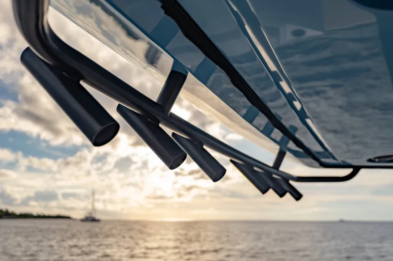 Slide: The Image of Close-up of 2027 Axopar 38 Cross Top boat detail against sunset on the water. - 15