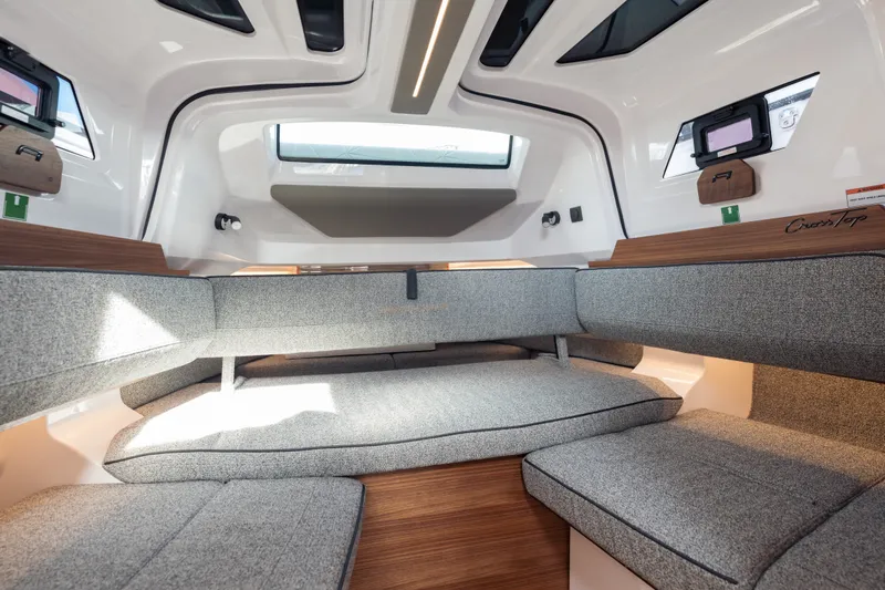 Slide: The Image of Interior of 2027 Axopar 38 Cross Top boat with modern seating and wood accents. - 33