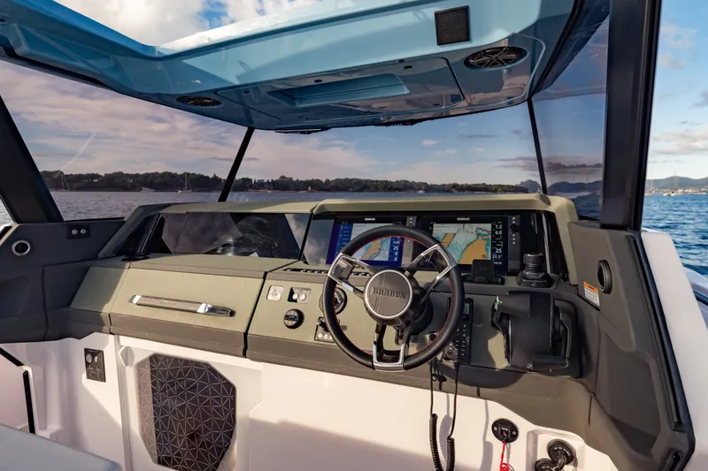 Slide: The Image of Helm of 2027 Axopar 38 Cross Top boat with advanced navigation system. - 30