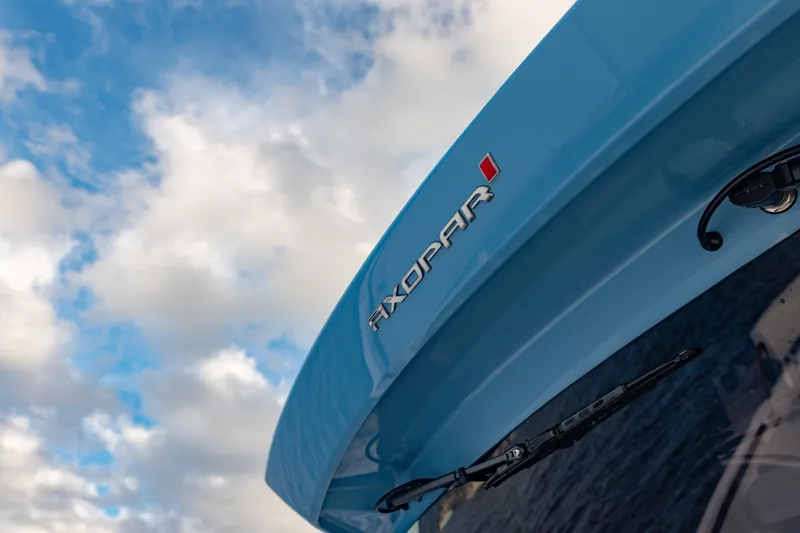 Slide: The Image of 2027 Axopar 38 Cross Top boat against a cloudy sky background. - 16