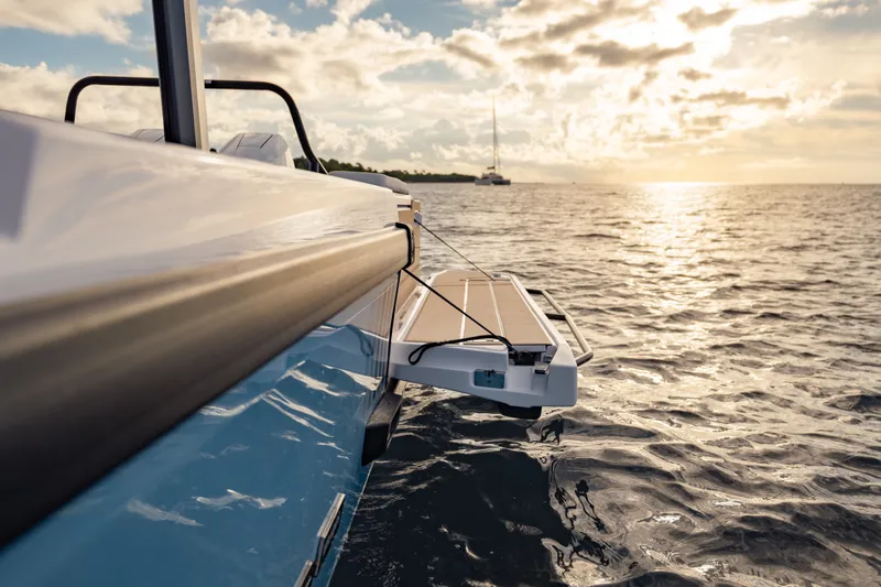 Slide: The Image of 2027 Axopar 38 Cross Top boat on serene ocean at sunset. - 18
