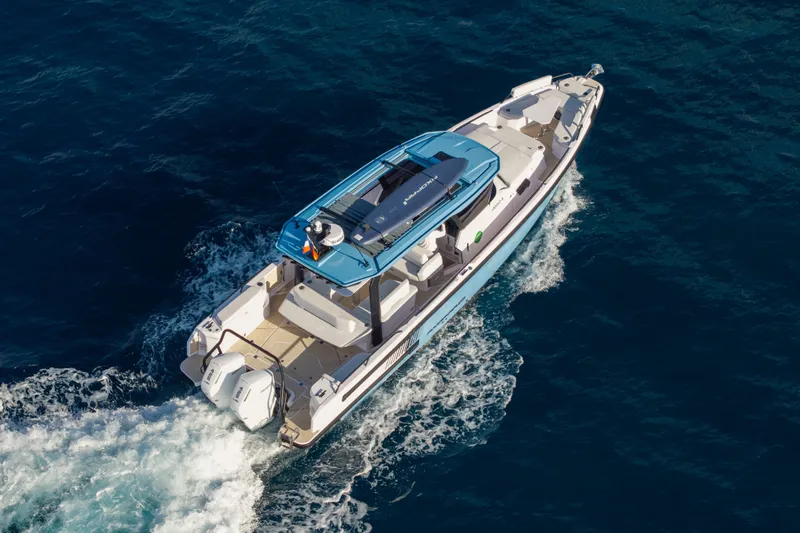 Slide: The Image of 2027 Axopar 38 Cross Top boat cruising on open blue water. - 11