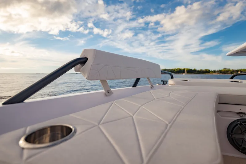 Slide: The Image of 2027 Axopar 38 Cross Top boat interior with cushioned seating and ocean view. - 21