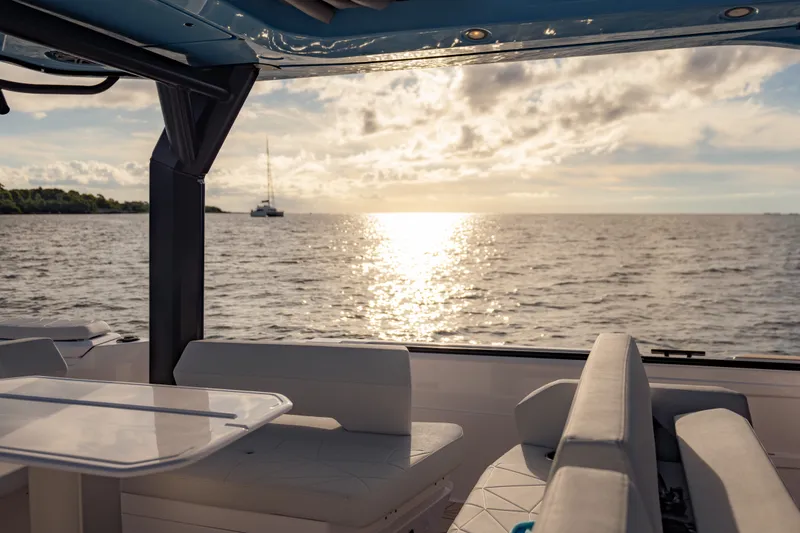 Slide: The Image of Interior view of 2027 Axopar 38 Cross Top boat with ocean sunset. - 28