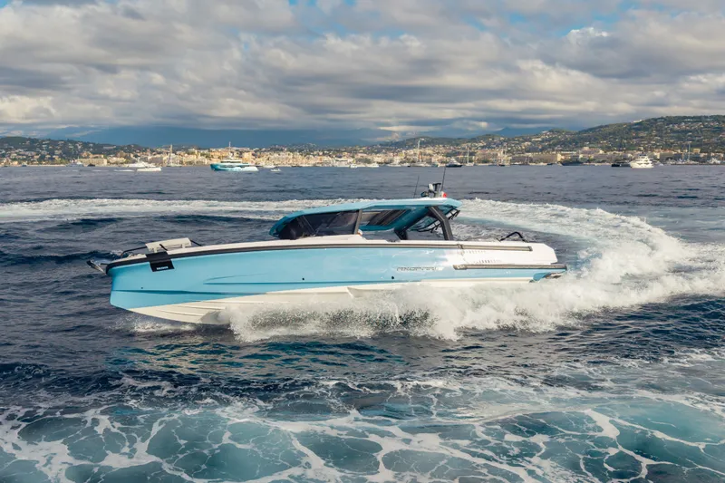 Slide: The Image of A 2027 Axopar 38 Cross Top boat speeding across the sea. - 4