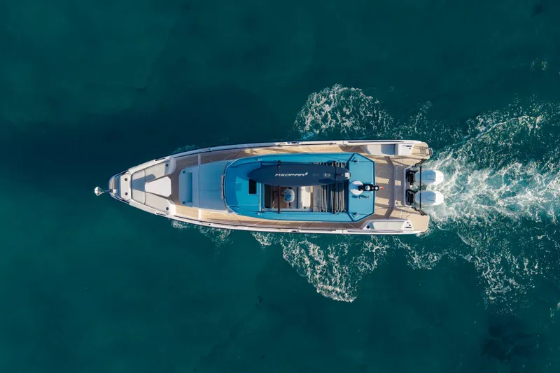 Slide: The Image of Top view of 2027 Axopar 38 Cross Top boat cruising on clear blue water. - 9
