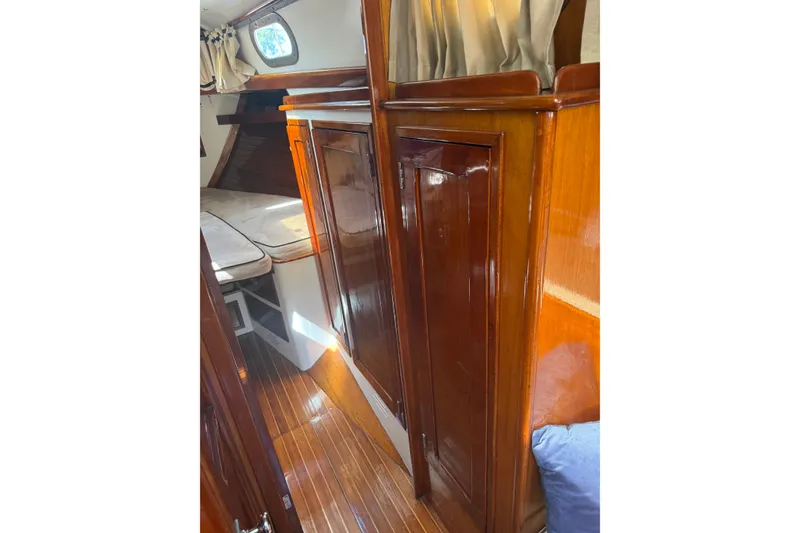 Slide: The Image of Interior of 1965 Hinckley Yachts Bermuda 40 with polished wood and cozy cabin space. - 13