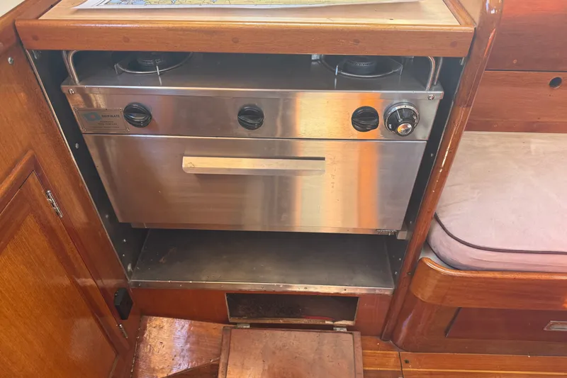 Slide: The Image of Stainless steel stove in 1965 Hinckley Yachts Bermuda 40 interior, wooden cabinetry. - 15