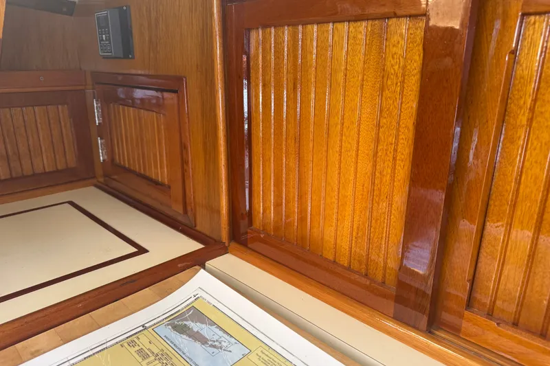 Slide: The Image of Interior of a 1965 Hinckley Yachts Bermuda 40, featuring polished wooden cabinetry. - 17